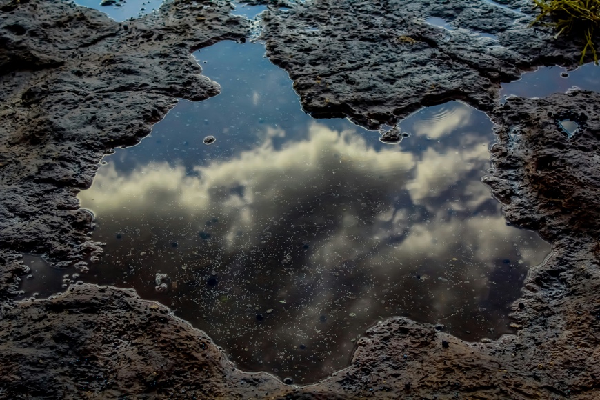 A still rock pool reflecting the sky